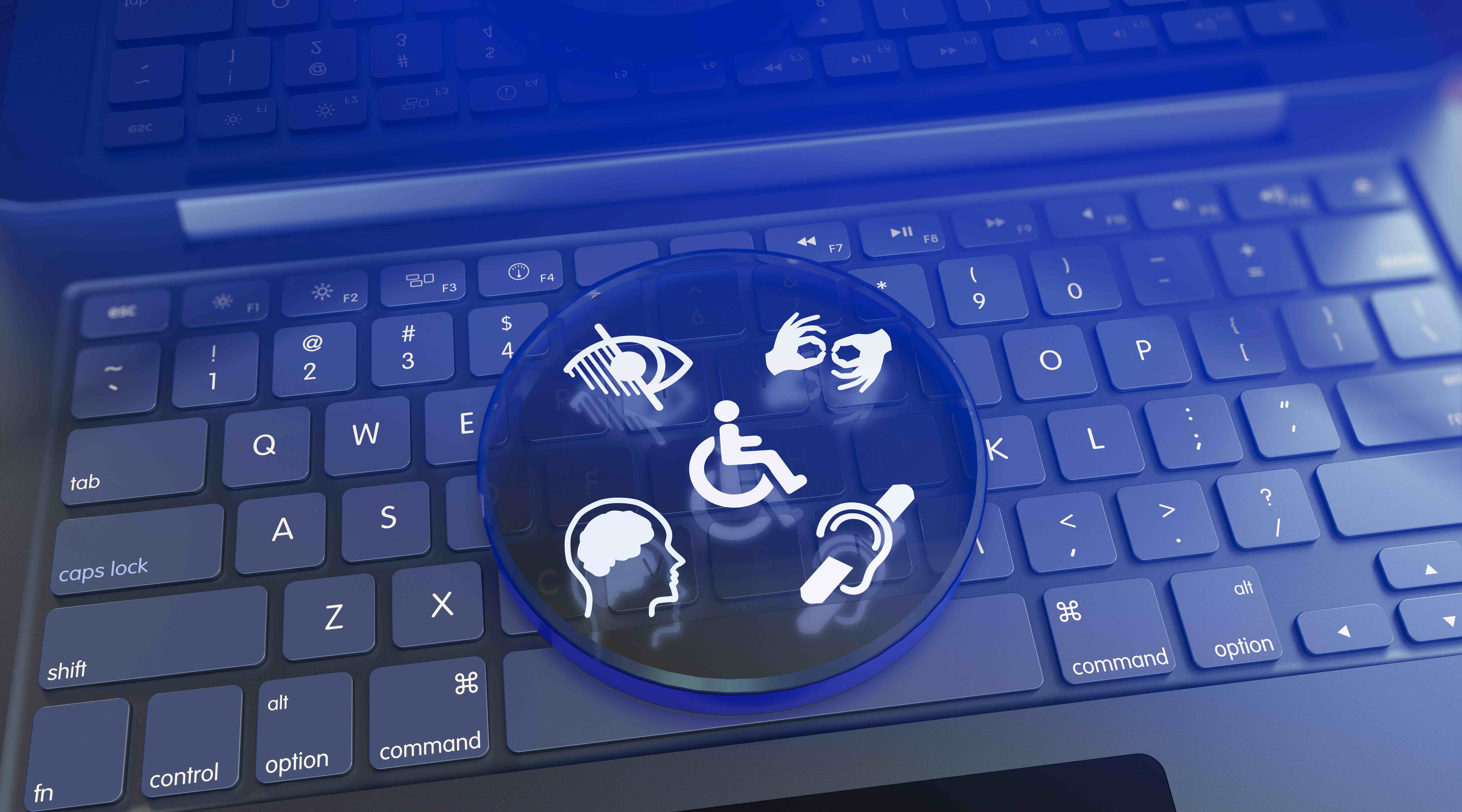 Laptop keyboard with icons showing blindness, deafness, and other disabilities